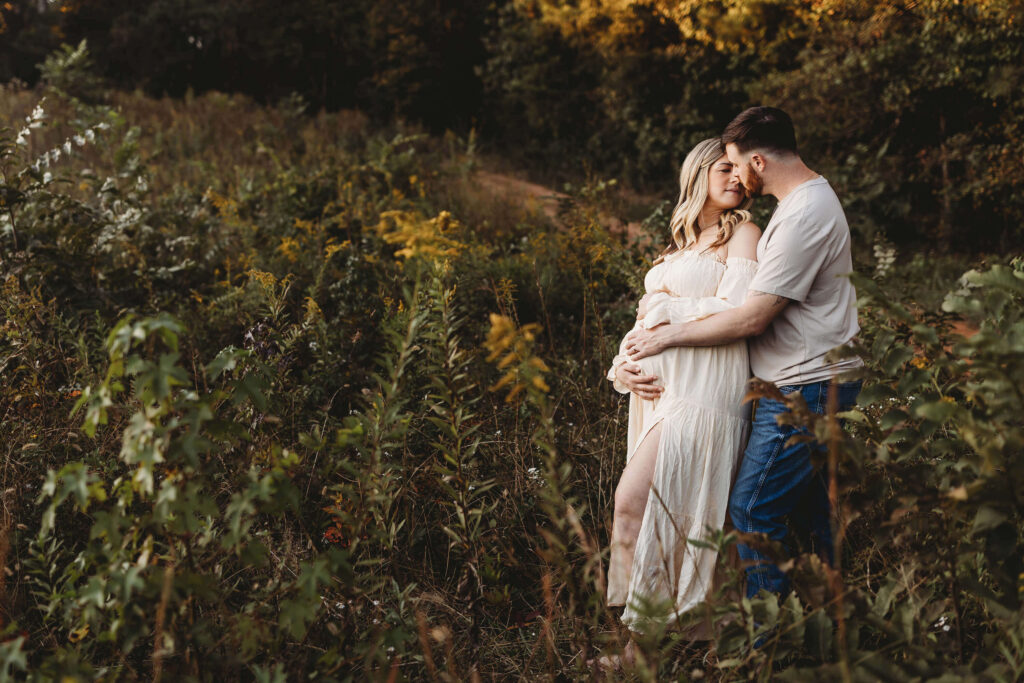 Marietta maternity session with expectant parents in golden hour field