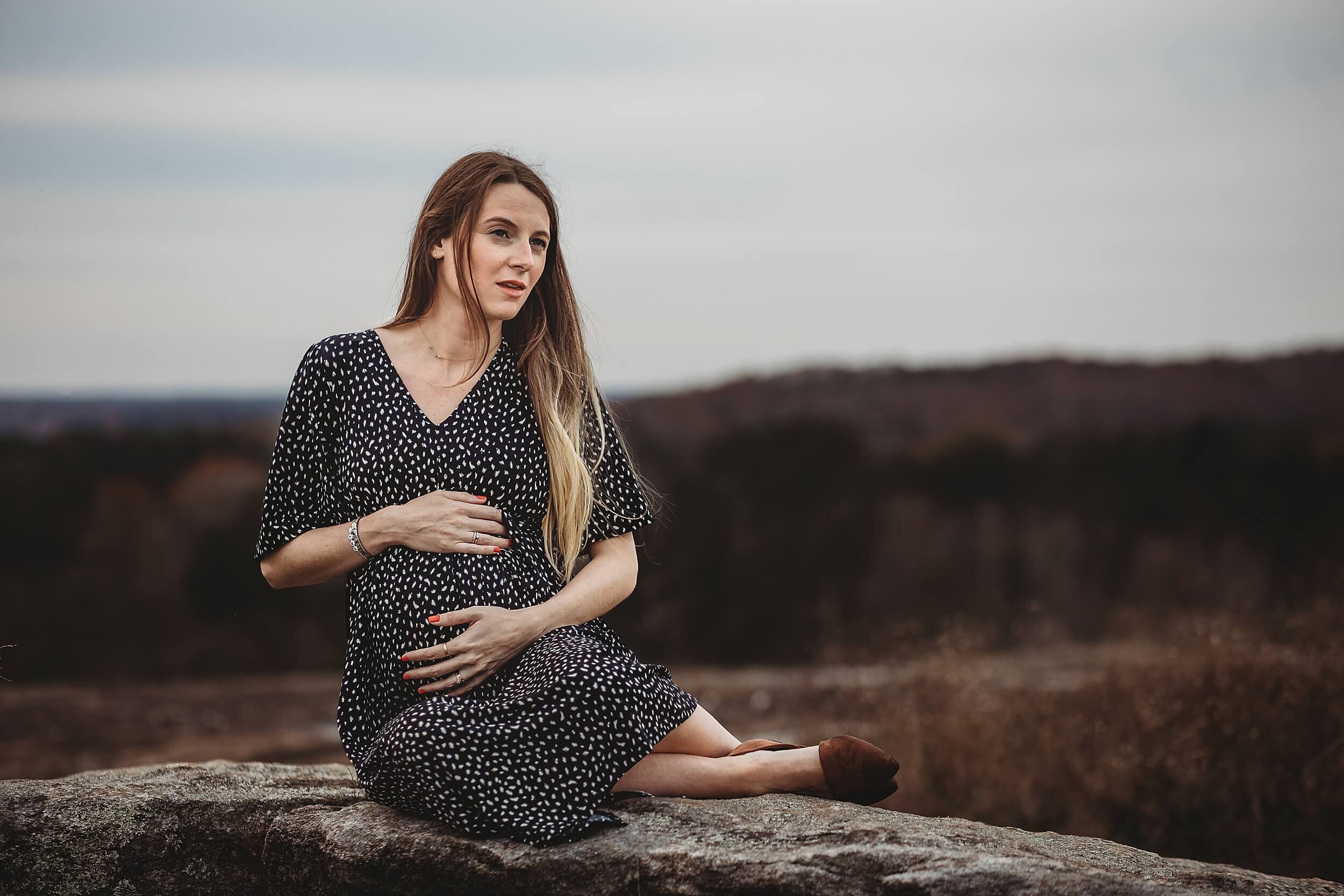 Maternity portrait at the top of Arabia Mountain with breathtaking views and dramatic landscape during an Atlanta pregnancy session