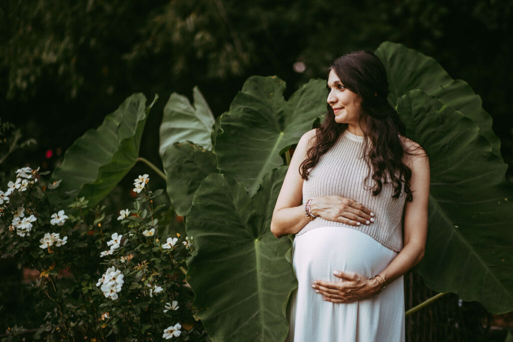 Intown Atlanta maternity session with lush elephant ear plants, photographed by an Atlanta maternity photographer