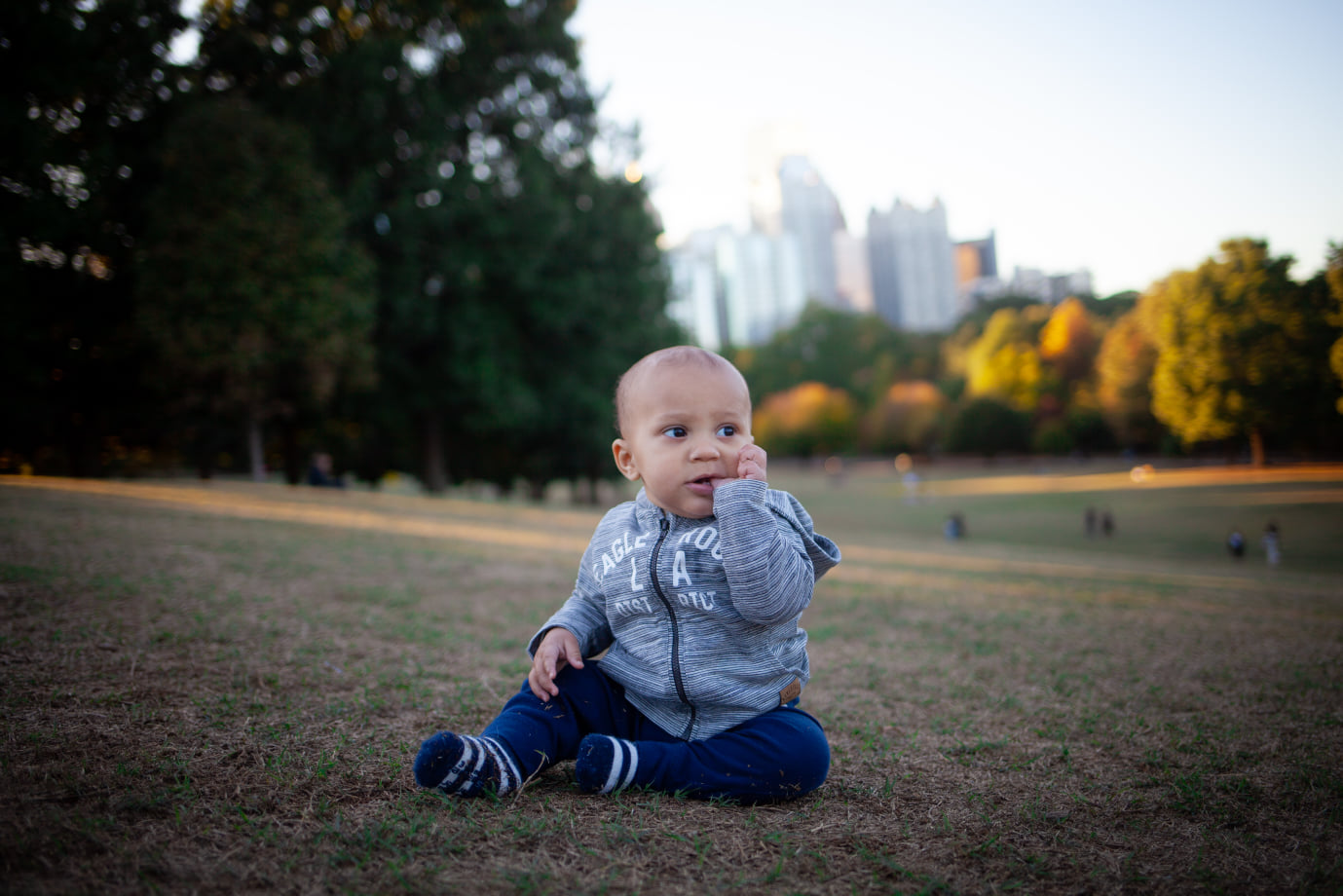 Toddler playing in the grass at Piedmont Park in Atlanta, Georgia
