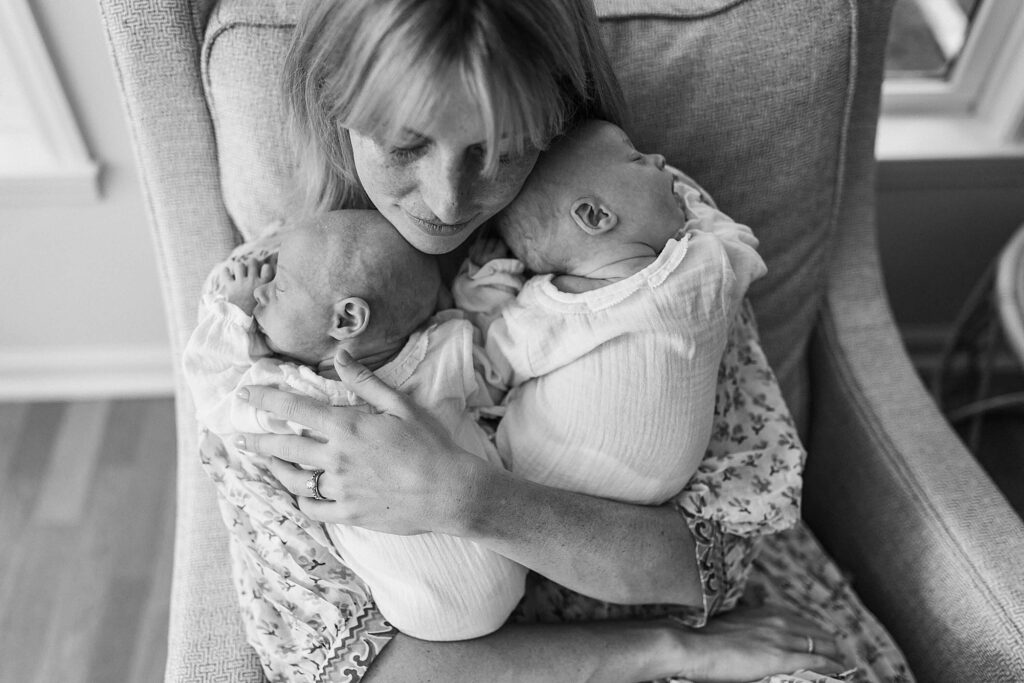 Atlanta mother holding her twin babies at home during their first year.