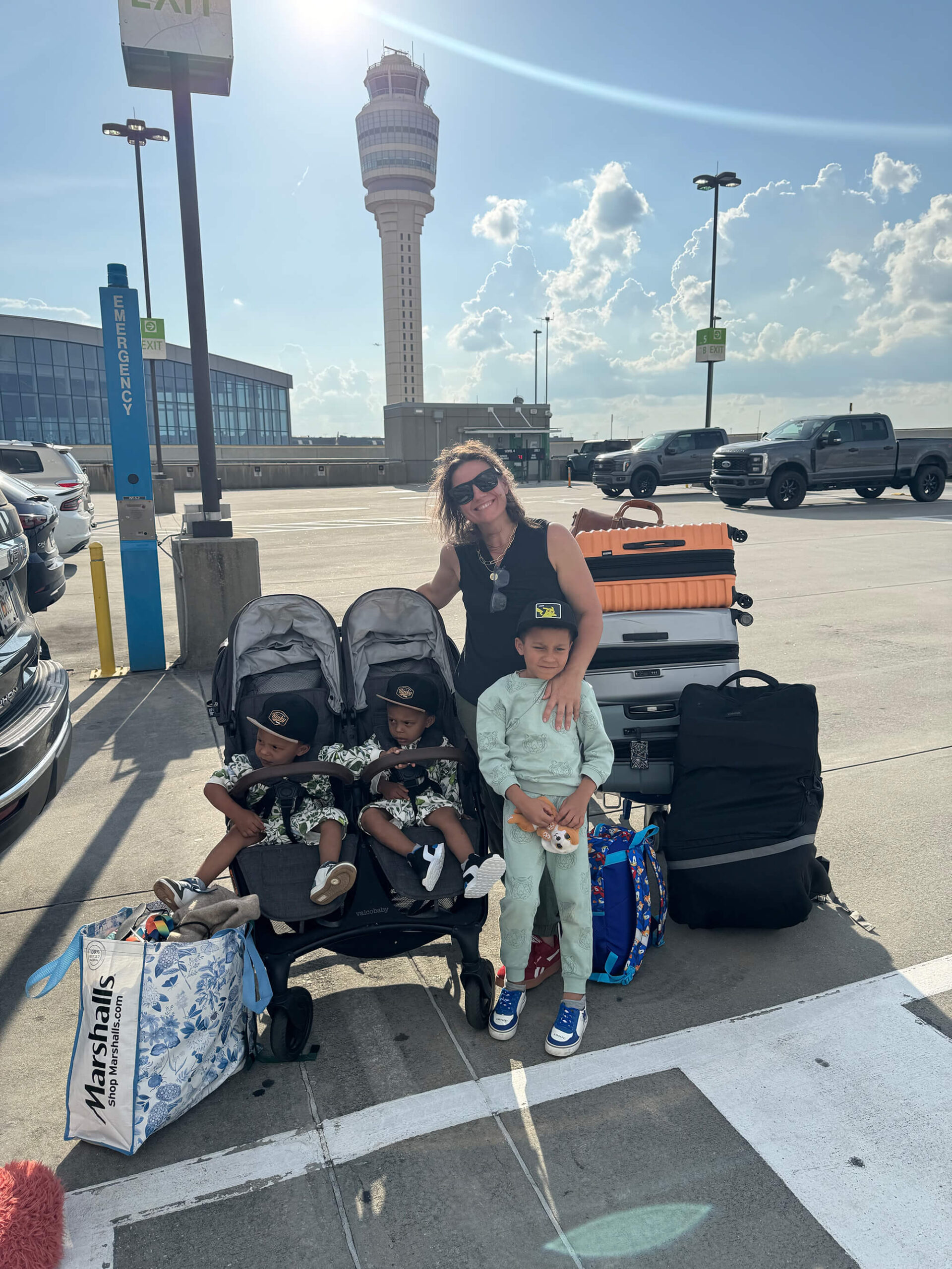 Mom flying internationally with three young children through the airport.
