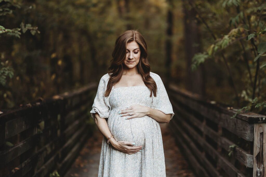 Pregnant mother wearing a modern floral dress during an Atlanta maternity photography session.