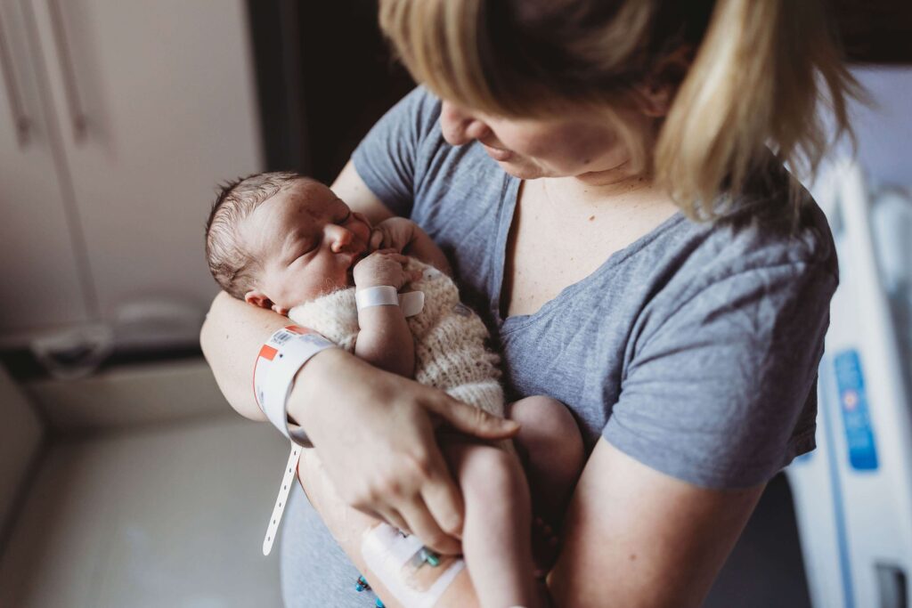 Mom holding one day old baby
