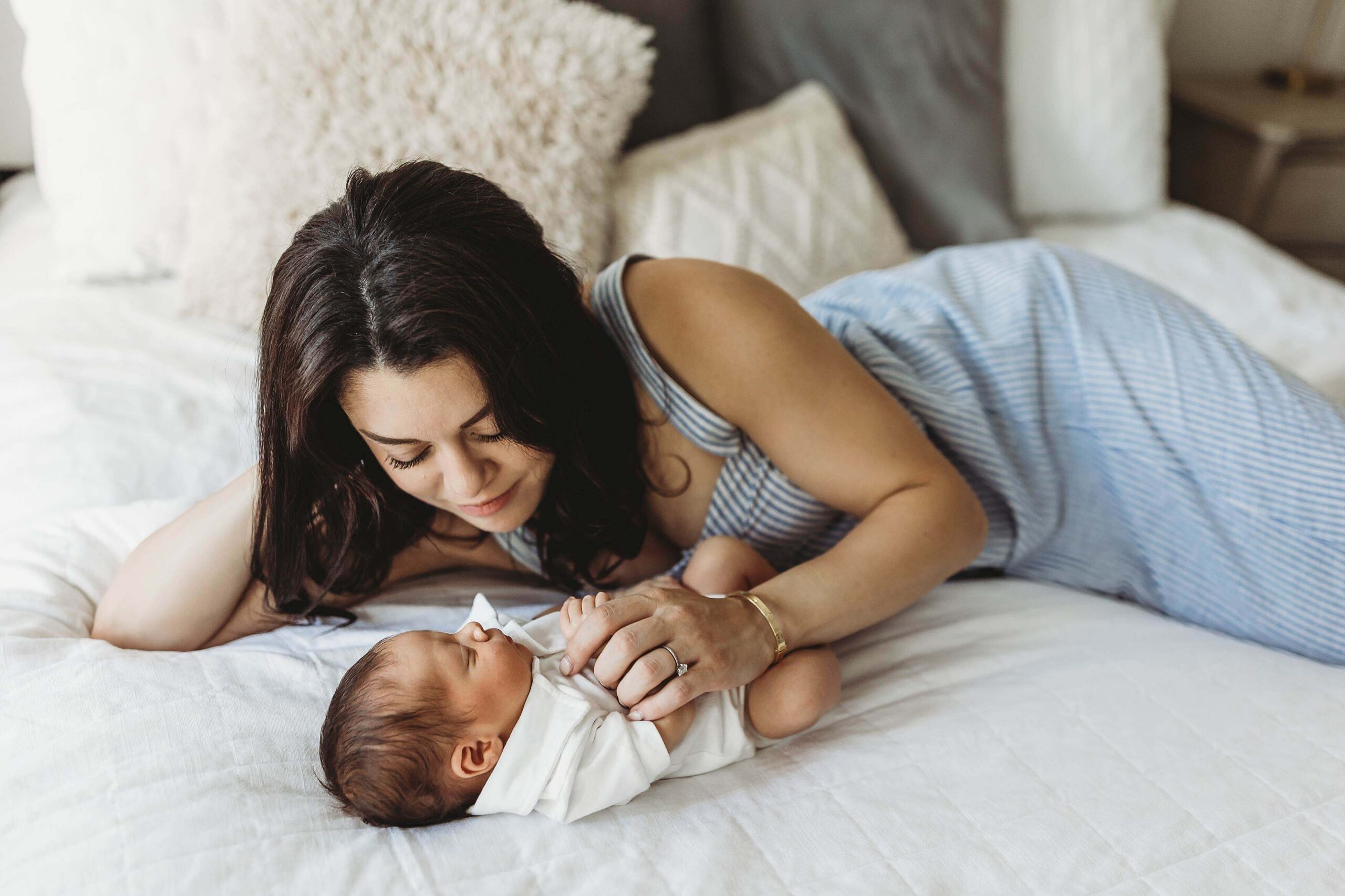 Mom holding newborn baby thinking about options for pelvic floor therapy in Atlanta