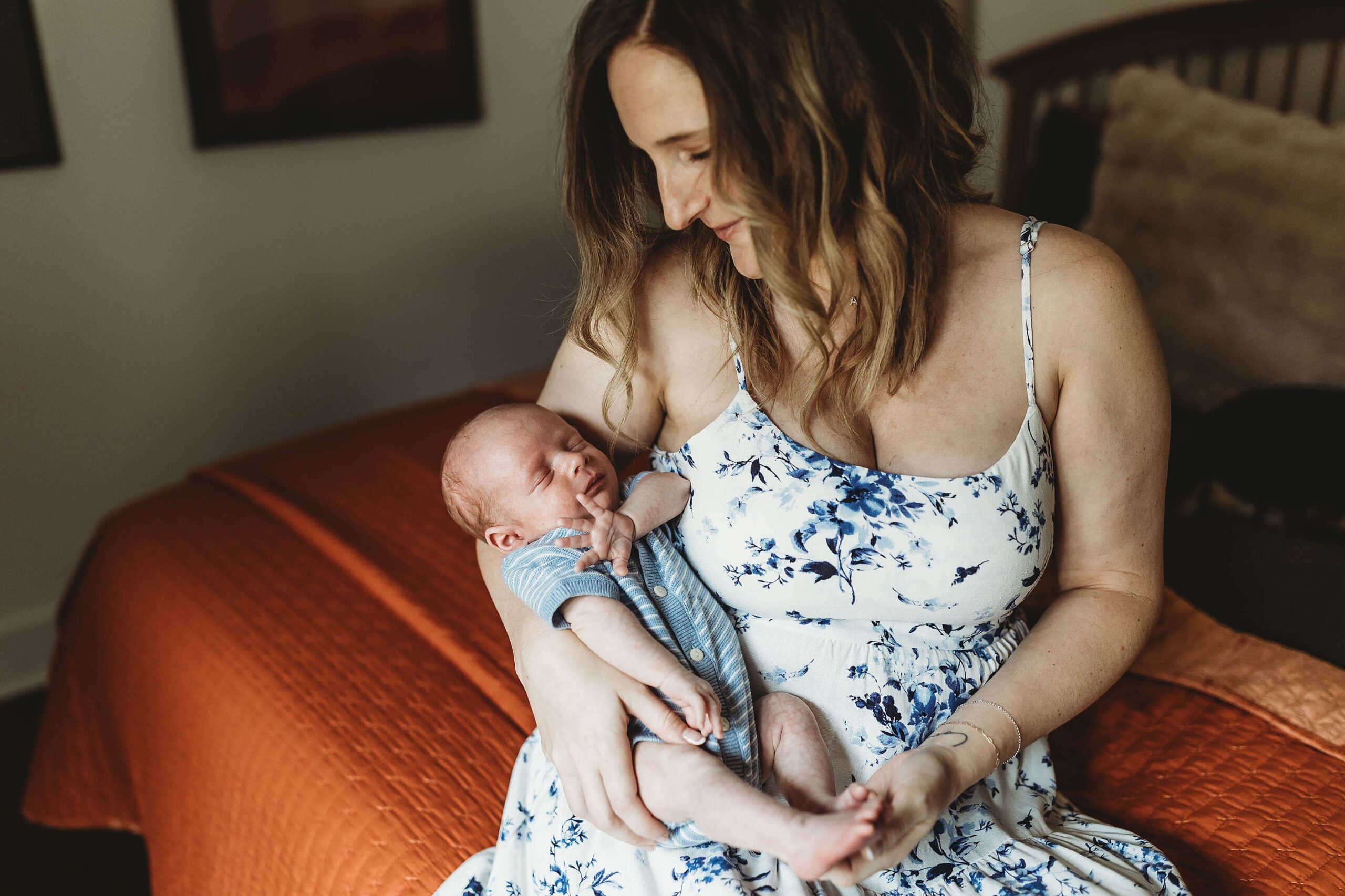 Mom holding newborn baby and thinking about Atlanta night nurse services